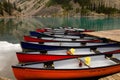 Scenic view of several canoes resting in shallow waters of the Lake Moraine Royalty Free Stock Photo