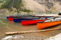 Scenic view of several canoes resting in shallow waters of the Lake Moraine Royalty Free Stock Photo