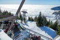 A scenic view of Skyride Gondola at The Peak of Vancouver above the White Puffy Clouds at sunset. Attitudes bistro lookout