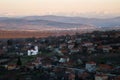 Scenic view of Slavyani village church with Lovech city in the background. Balkan mountain range in Bulgaria, evening light Royalty Free Stock Photo