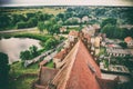 Scenic view of a small town, a pond and a tile church roof, old photo stylization