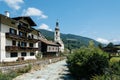 Scenic view of small village and white church in the Alps