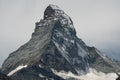 Snow-capped peak of the Matterhorn mountain against cloudy sky in Zermatt Village, Switzerland Royalty Free Stock Photo