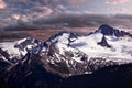 Scenic view of snow covered mountain peaks at sunrise. Royalty Free Stock Photo