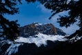 Scenic view of snow covered mountains and forest in Canada with blue sky and shadow from clouds Royalty Free Stock Photo