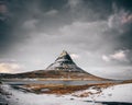 Scenic view of snowy field, river and mountain landscape in Kirkjufell, Iceland