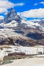 Scenic view on snowy Matterhorn mountain peak in the Swiss Alps with cogwheel train of Gornergrat railway close to Zermatt, Royalty Free Stock Photo