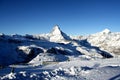 Scenic view on snowy Matterhorn peak in sunny day with blue sky and some clouds in background Royalty Free Stock Photo