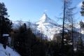 Scenic view on snowy Matterhorn peak in sunny day with blue sky and some clouds in background Royalty Free Stock Photo