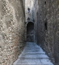 Scenic view of stone steps leading up to an arch in a narrow alleyway Royalty Free Stock Photo