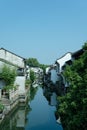 Scenic view of a street corner featuring an array of traditional terraced houses between a canal Royalty Free Stock Photo