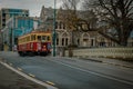 Scenic view of a street with a red vintage tram in Christchurch city of New Zealand