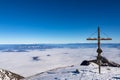 Scenic view from the summit cross of Hochobir on snow capped mountain peaks in the Karawanks in Carinthia, Austria. Winter