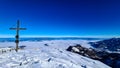 Scenic view from the summit cross of Hochobir on snow capped mountain peaks in the Karawanks in Carinthia, Austria. Winter