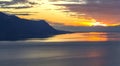 Scenic view of sunset over the Leman lake with yellow sky with clouds and Alps mountains in background, Montreux, Switzerland. Royalty Free Stock Photo