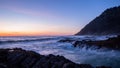 Scenic view of a sunset over ocean. Crushing waves enter into a chasm at Cape Perpetual, Oregon Coast