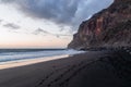 Scenic view during sunset on the volcanic sand beach Playa del Ingles in Valle Gran Rey, La Gomera. Footprint in sand