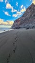 Scenic view during sunset on the volcanic sand beach Playa del Ingles in Valle Gran Rey, La Gomera. Footprint in sand