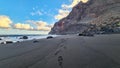 Scenic view during sunset on the volcanic sand beach Playa del Ingles in Valle Gran Rey, La Gomera. Footprint in sand