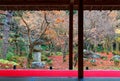 Scenic view from a tatami room by a Japanese courtyard garden with colorful maple trees & fallen leaves Royalty Free Stock Photo