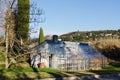 Scenic view to beautiful glass greenhouse at green hills against blue sky in spring in Slovenian coast. Royalty Free Stock Photo