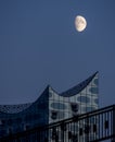 Scenic view to elbphilharmony with huge moon visible close to modern building hamburg