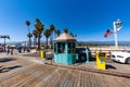 scenic view to historic wooden pier in Santa Barbara, USA with green painted entrance booth for cars
