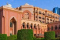 Scenic view to facade with arabesque arched windows and national UAE flags from courtyard side of luxury Emirates Palace UAE
