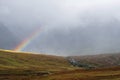 Scenic view to Scottish highlands with rainbow through the clouds Royalty Free Stock Photo