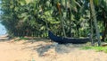 Scenic view to tropical beach  with  traditional fishing boat and beach huts on the coconut trees background in Kerala, South Royalty Free Stock Photo