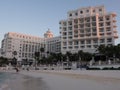 Scenic view to white hotels buildings on beach at bay of Caribbean Sea in Cancun city in Mexico with tourists