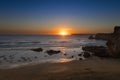 Scenic view of the Tonel Beach Praia do Tonel in Sagres, Algarve, at sunset, with the Cabo de Sao Vincente on the backround Royalty Free Stock Photo