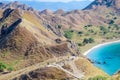 Scenic view from the top of Padar Island. Tourists enjoying the Savanna hill and taking pictures Royalty Free Stock Photo
