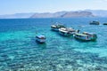 Scenic view of tourist ships anchored in a bay, which is a favorite spot for tourists to enjoy underwater views