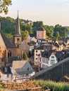 Scenic view of tourist town Saarburg in Germany, St. Lawrence church and city river with waterfall and water mill Royalty Free Stock Photo
