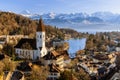 Scenic view of traditional buildings surrounding the tranquil Thun lake in Switzerland in autumn Royalty Free Stock Photo