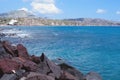 Scenic view of the turquoise sea, red rocks, blue sky, clouds on the island of Santorini, Greece. Greek coast. Royalty Free Stock Photo