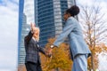 Scenic view of two multi-ethnic businesswomen greeting each other outside of the office Royalty Free Stock Photo