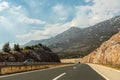 Scenic view of an unpopulated highway surrounded by green hills and mountains during a day, Croatia