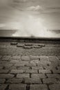 Scenic view on vertical sprays of sea water waves passing through underground floor channels in san sebastian, spain in black and Royalty Free Stock Photo