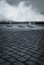 Scenic view on vertical sprays of sea water waves passing through underground floor channels in san sebastian, spain in black and Royalty Free Stock Photo