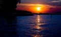 Scenic view of a vibrant orange sunset reflected over the clear waters of the Missouri river Royalty Free Stock Photo