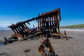 Scenic view of a vintage shipwreck on the Oregon coast near the tranquil body of water Royalty Free Stock Photo