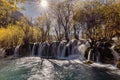 Scenic view of a waterfall cascading down a forested mountain in autumn Royalty Free Stock Photo