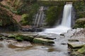 Scenic view of a waterfall flowing down the rocks covered with moss in Wepre Park, North Wales Royalty Free Stock Photo