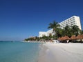 Scenic view of white hotels building on sandy beach at bay of Caribbean Sea in Cancun city in Mexico with tourists Royalty Free Stock Photo