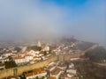 Scenic view of white houses red tiled roofs, and castle from wall of fortress with clouds. Obidos village, Portugal. Royalty Free Stock Photo