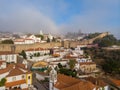 Scenic view of white houses red tiled roofs, and castle from wall of fortress with clouds. Obidos village, Portugal. Royalty Free Stock Photo