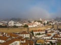 Scenic view of white houses red tiled roofs, and castle from wall of fortress with clouds. Obidos village, Portugal. Royalty Free Stock Photo