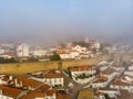 Scenic view of white houses red tiled roofs, and castle from wall of fortress with clouds. Obidos village, Portugal. Royalty Free Stock Photo